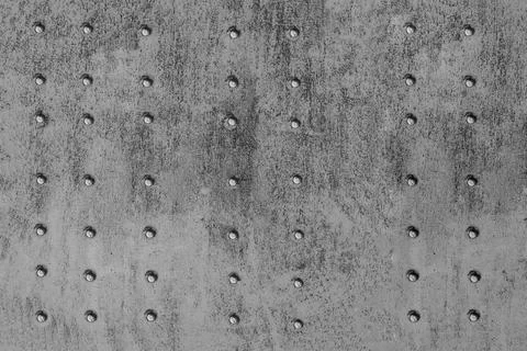 Riveted metal surface, painted grey. Stock Photos