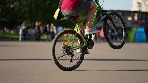 Rivne, Ukraine - August 29, 2023: A guy rides a bicycle on the back wheel Stock Footage 252184694