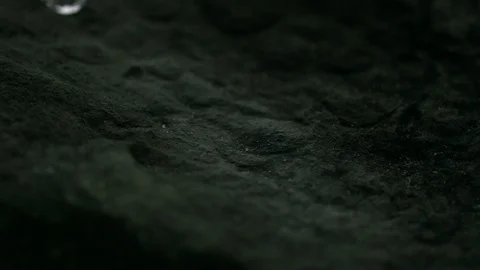 Rivulet of water running down a stone in slowmotion HD Stock Footage 98992576