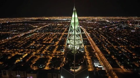 Riyadh Al Faisaliyah Center at night aerial Stock Footage