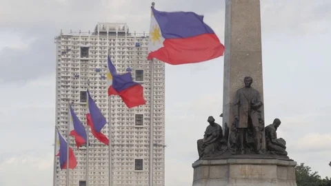 Rizal monument and national filipino flag,Manila,Luzon,Philippines Stock Footage