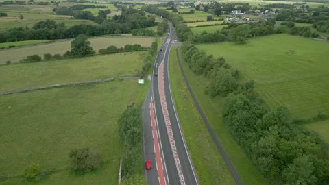 Road A66 cutting through green summer landscape and patchwork fields. Video stock 247975472
