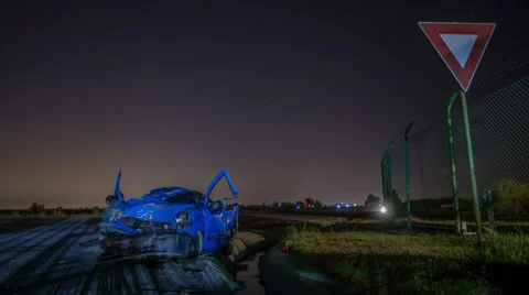 Road accident. Crashed car on the road time lapse, close to a give way  sign Stock Footage 63630803