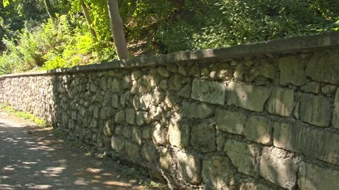 Road along the old stone wall. Stock Footage 80417021