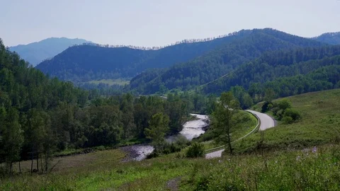 The road along the river located between the green hills Video stock 79731861