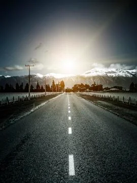 Road to the alps with dramatic sun light Stock Photos