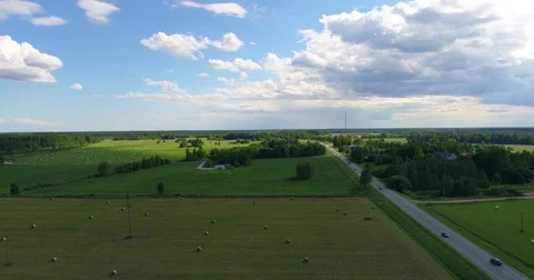 Road among fields, on a summer day. Aerial footage. Stock Footage
