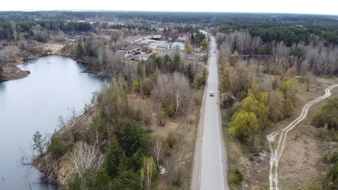 Road among trees near lake aerial view Stock Footage 129658341