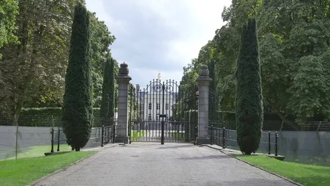 Road and closed palace gate with trees around Stock Footage 73701596