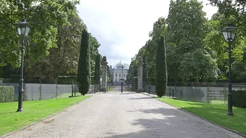Road and closed palace gate with trees around Stock Footage 73701680
