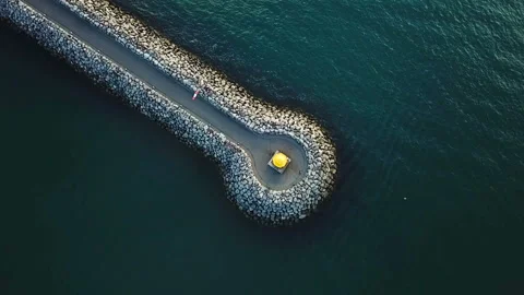 Road and a lighthouse in the sea. view from above. mood aeriel video footage Vídeo Stock 90905375