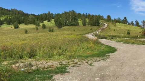 A road and a mountain meadow 库存影片 92850125