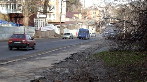 The road and part of the sidewalk with passing cars Stock Footage 83454478