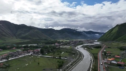 Road And River Through Green Highland Town in Sichuan, China Stock Footage 344034994