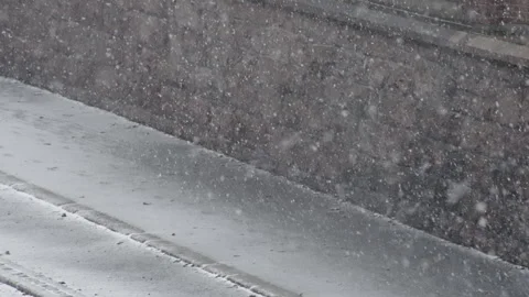 Road and stone wall during heavy snowfall Stock Footage 268693125