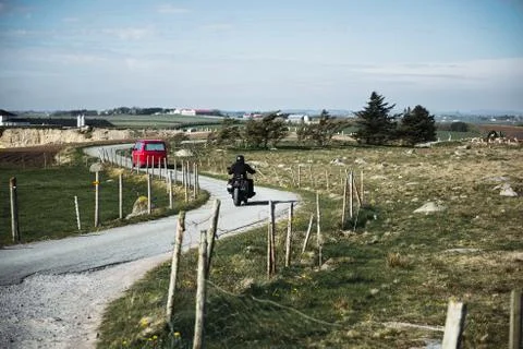 Road background with small red bus and motocycle Stock Photos