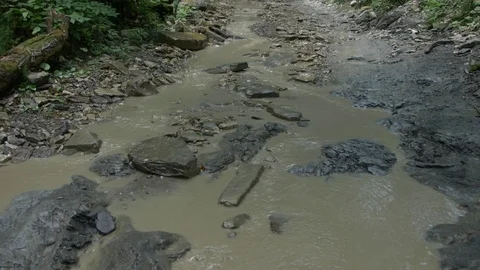  Road on the Bed of a Dirty Mountain River Video stock 105263231