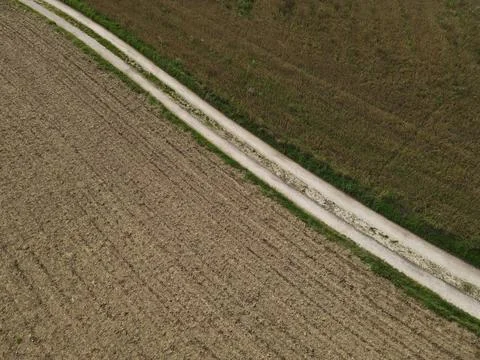 Road between fields in the countryside Stock Photos