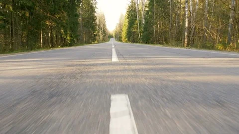Road between forest - flying camera shot Video stock 77807635