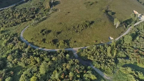 Road between green hills Видео 165329040