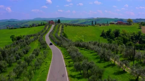 Road between green spring hills in Tuscany, Italy. Aerial view Stock Footage 224502292