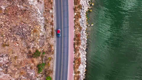 Road  between a lake a mountain Stock Footage 310303421