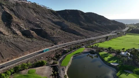 Road Between Mountains and Green Fields Leading to Ocean – Gran Canaria Aerial Stock Footage 309951644