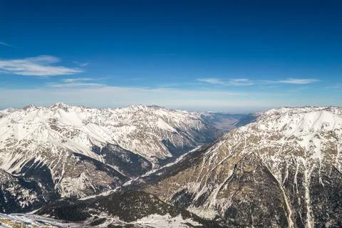 Road between mountains in winter Stock Photos