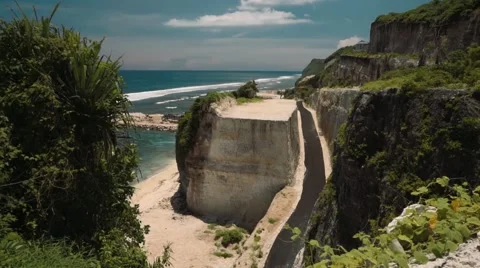 Road between two cliffs and ocean - view from above, south Bali Stock Footage 65243159