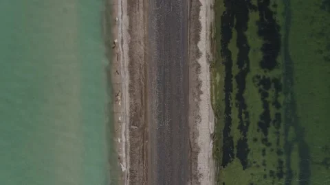 A road between two lakes with different color Stock Footage 138913751