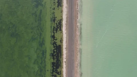 A road between two lakes with different color Stock Footage 138913945