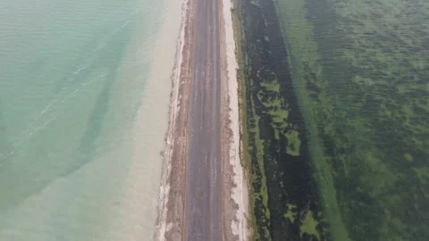 A road between two lakes with different color Stock Footage 138913992