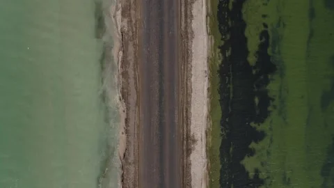 A road between two lakes with different color Stock Footage 138914308