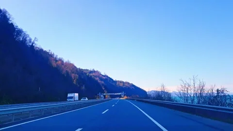 A road with a blue sky and trees Stock Footage 273013167