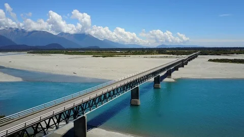 Road bridge across the river with mountain scenery in summer of New Zealand 스톡 동영상 99327419