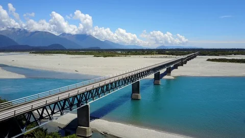 Road bridge across the river with mountain scenery in summer of New Zealand Stock-Footage 99328433
