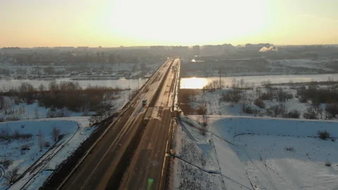 Road bridge over the river in winter against the evening city. 4K Stock Footage 105985544