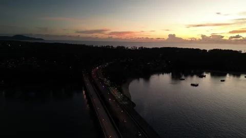 A road bridge over the strait during a crimson sunset. Drone video Stock Footage 305079265