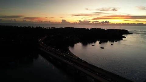 A road bridge over the strait during a crimson sunset. Drone video Stock Footage 305079493