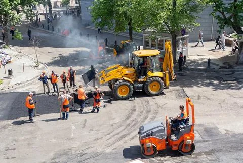 Road builders work is underway to replace asphalt on the roadway Stock Photos