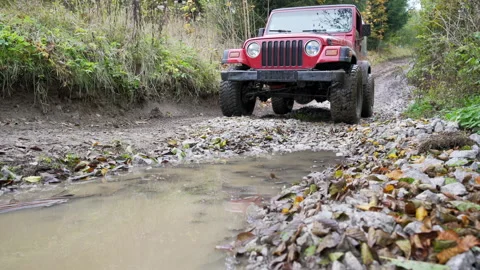 Off road car driving through a mud and water Stock Footage 158974798