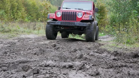 Off road car driving through a mud Stock Footage 158974814