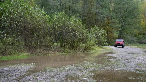 Off road car driving through a mud and water Stock Footage 158974816