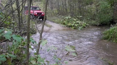 Off road car driving through a mud and water Stock Footage 158974826
