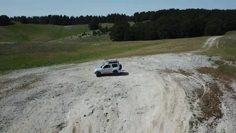 Off-road car in a mountain valley Stock Footage 92463417