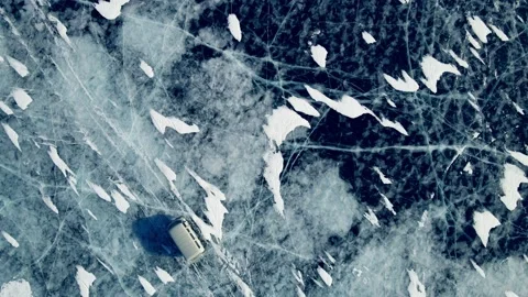 Off-road car rides on blue ice of Baikal lake in winter. Video stock 219963706