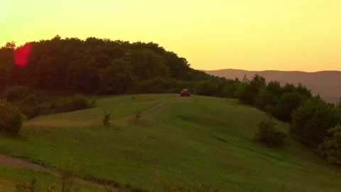 Off road car through hill at sunset Stock Footage 137633885