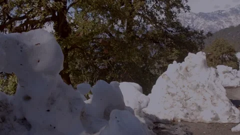 A road carved between snow and Mountains Stock Footage 324777552