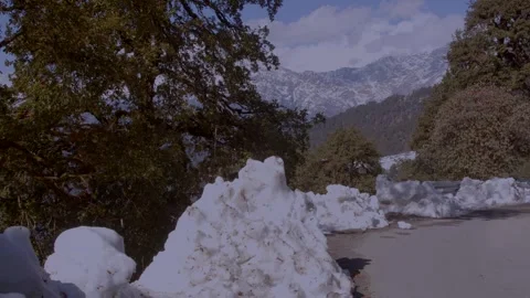 A road carved between snow and silence Mountains watching every turn Video stock 324777553