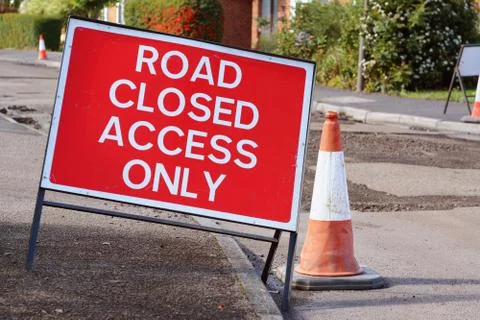 ROAD CLOSED ACCESS ONLY road sign with a traffic cone Stock Photos